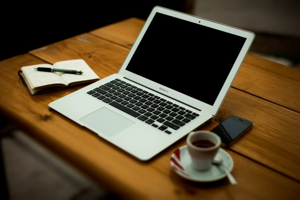 MacBook Air on brown wooden table